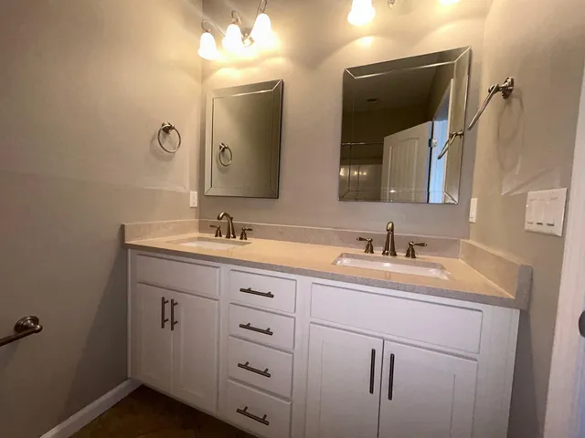 wooden floor in an empty room and a bathroom