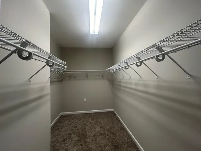 a bathroom with a tub a sink and mirror