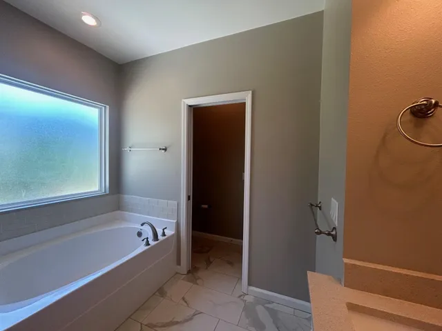 a white bath tub sitting next to a window