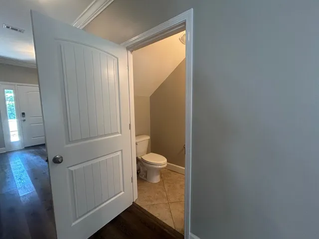 a bathroom with a granite countertop toilet and a shower
