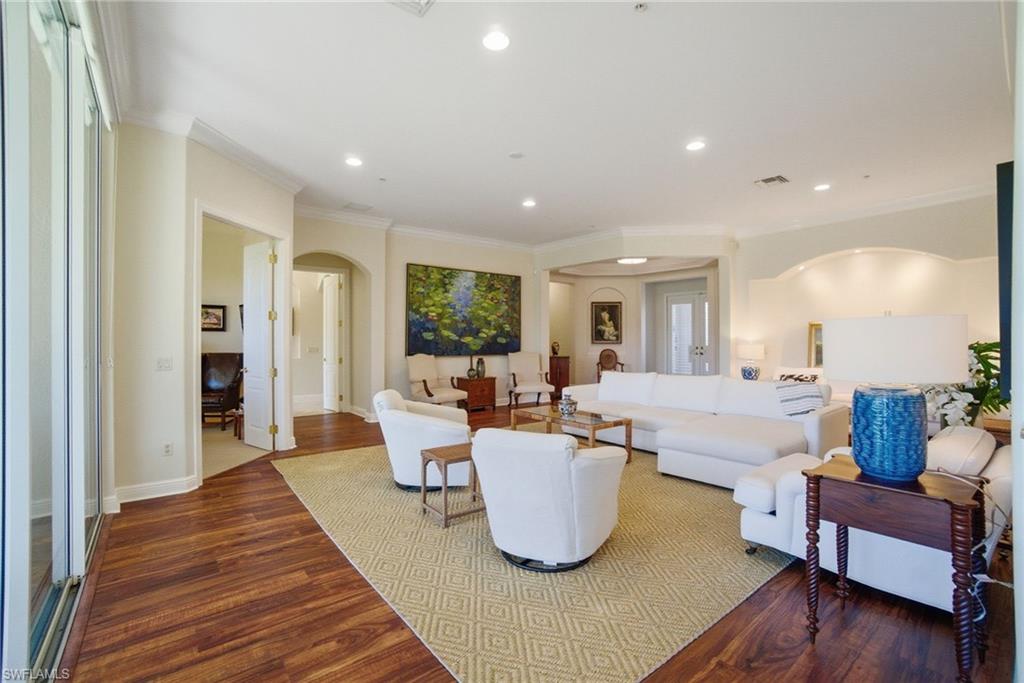 17015 Porta Vecchio Way, Unit 101 Naples, FL 34110 - Photo 5 of 39 a living room with furniture and a wooden floor