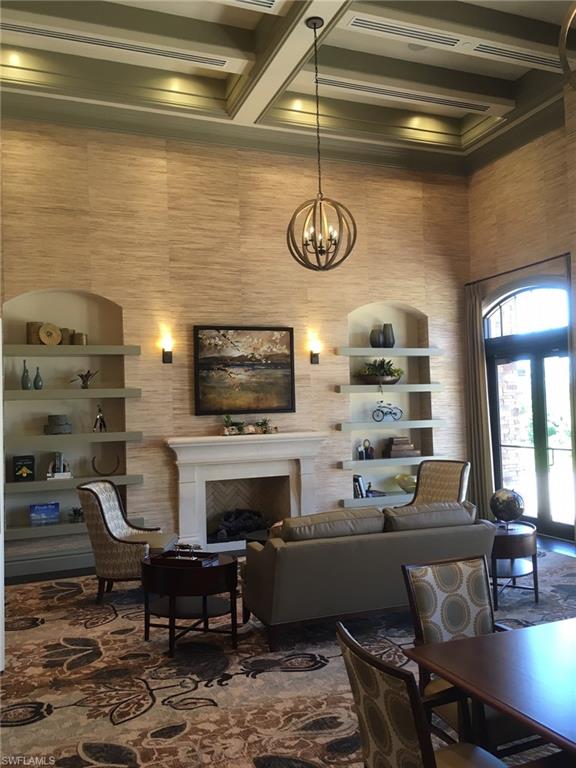 9522 Piacere Way Naples, FL 34113 - Photo 46 of 48 Living area with a fireplace, beamed ceiling, a high ceiling, a chandelier, and coffered ceiling