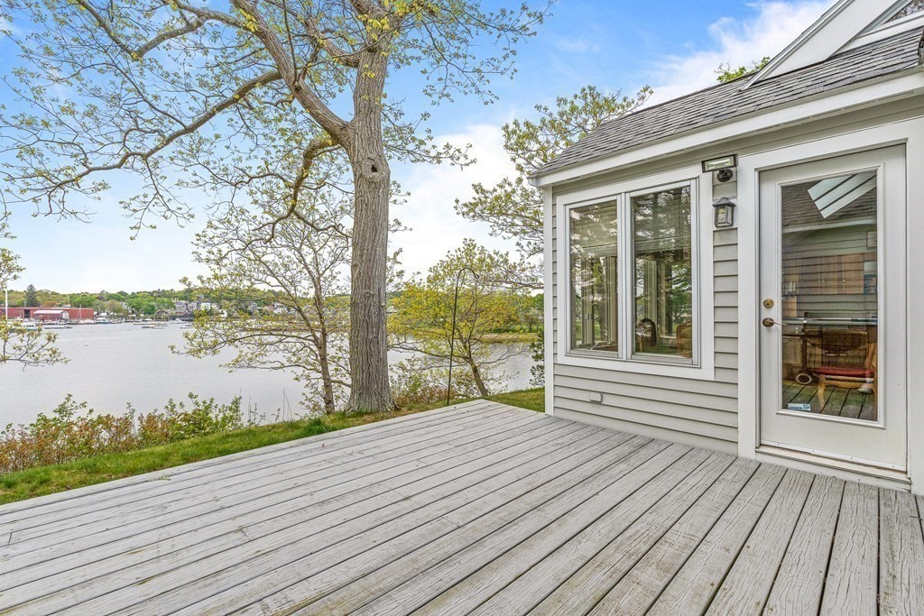 9 Proctor Street Manchester, MA 01944 - Photo 22 of 42 a view of a wooden deck with a lake view