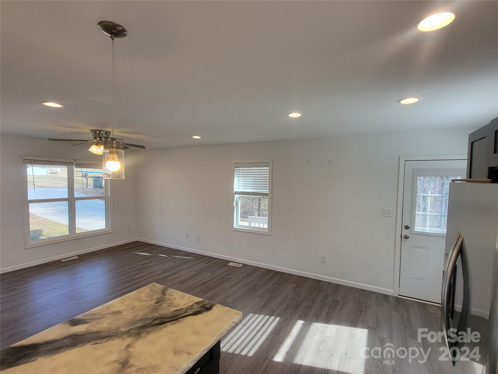 636 Hawthorne Street Hudson, NC 28638 - Photo 11 of 21 an empty room with wooden floor and a window