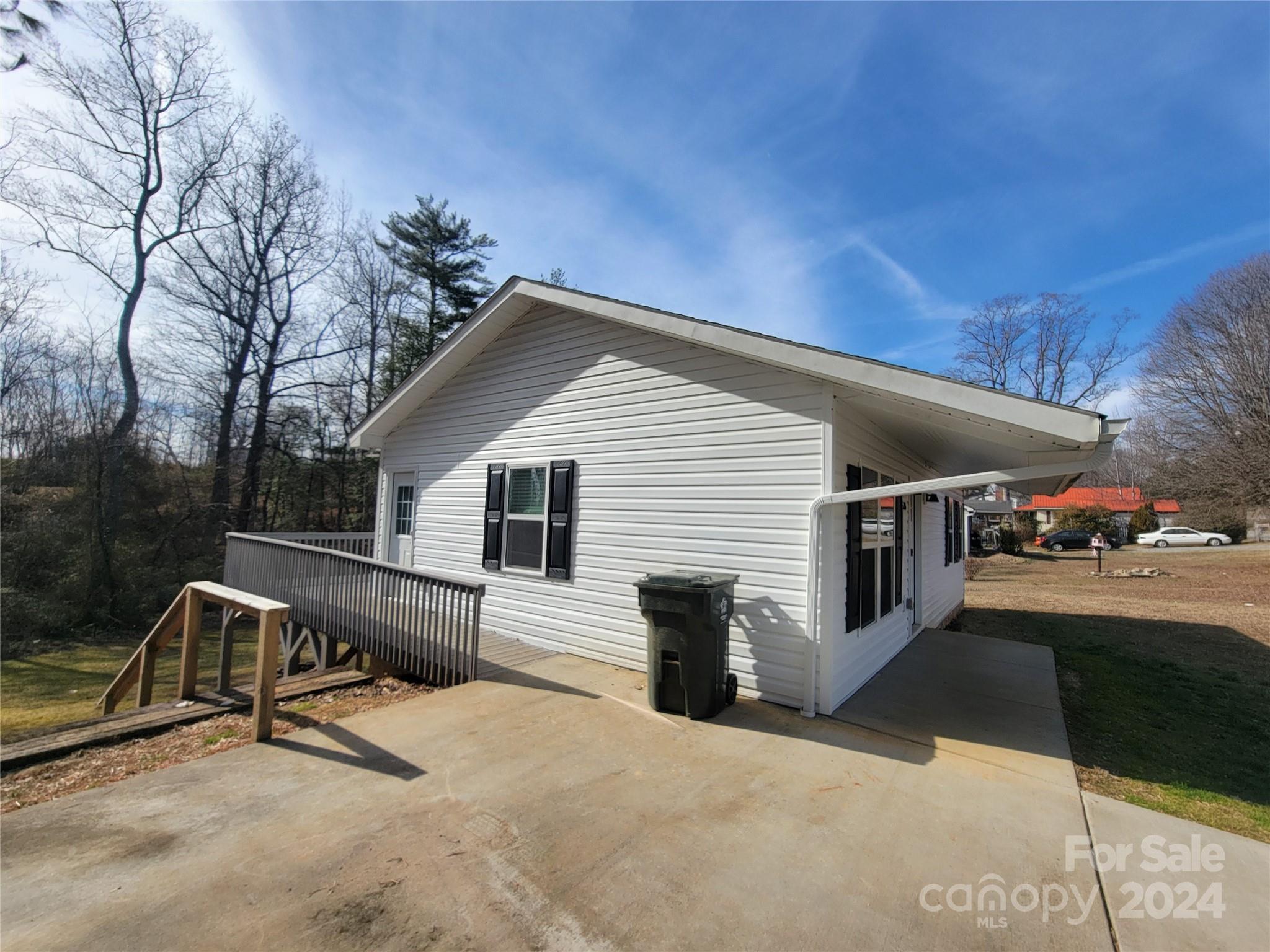 636 Hawthorne Street Hudson, NC 28638 - Photo 4 of 21 a view of a white house with a patio