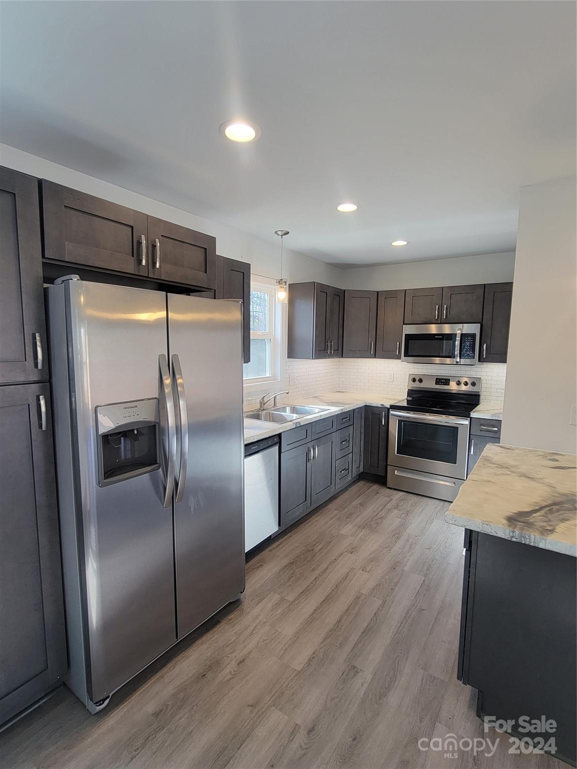 636 Hawthorne Street Hudson, NC 28638 - Photo 6 of 21 a kitchen with stainless steel appliances granite countertop a refrigerator a stove a sink and a microwave