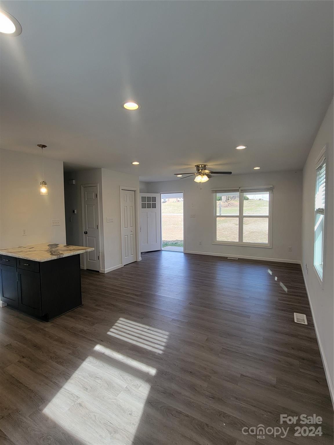 636 Hawthorne Street Hudson, NC 28638 - Photo 9 of 21 an empty room with wooden floor and windows