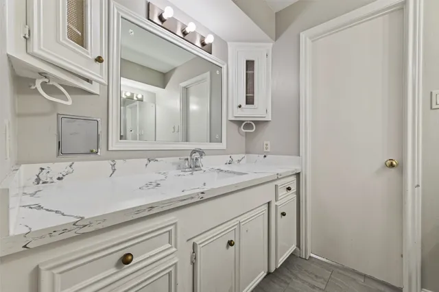a bathroom with a sink and a mirror