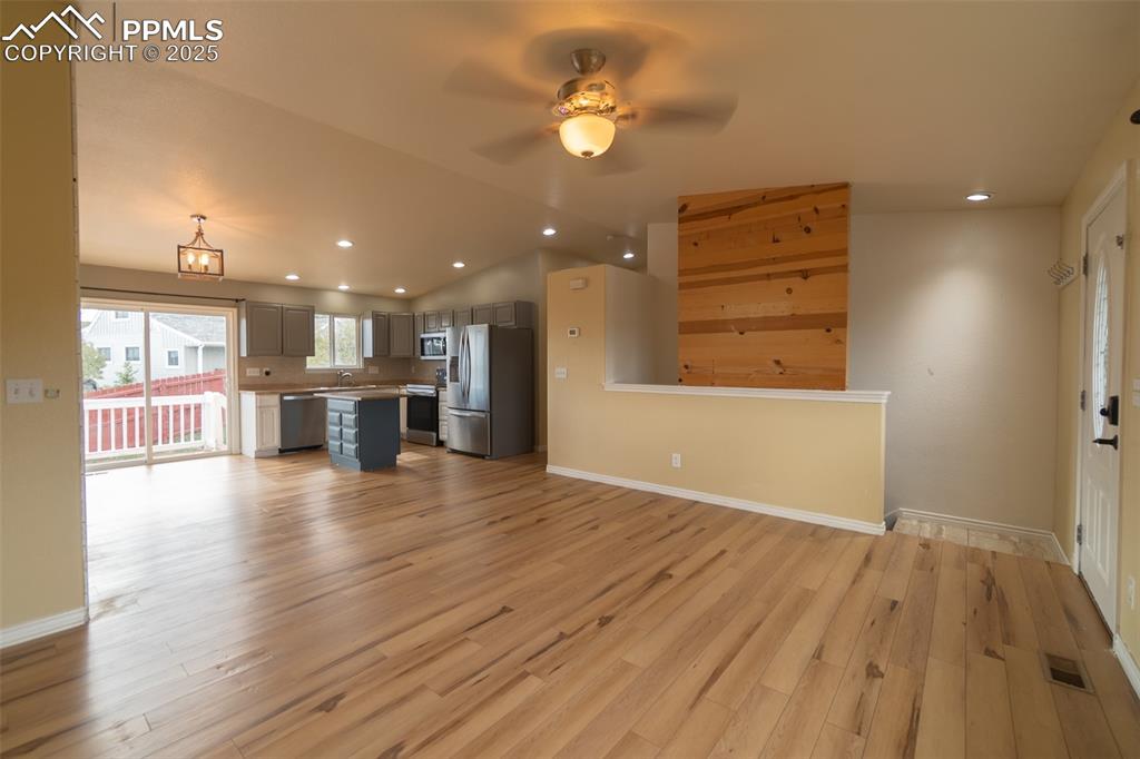 863 Circle Road Palmer Lake, CO 80133 - Photo 16 of 48 wooden floor in an empty room with a kitchen