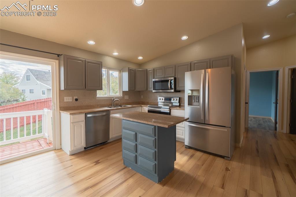 863 Circle Road Palmer Lake, CO 80133 - Photo 19 of 48 a kitchen with granite countertop a refrigerator stove top oven and sink