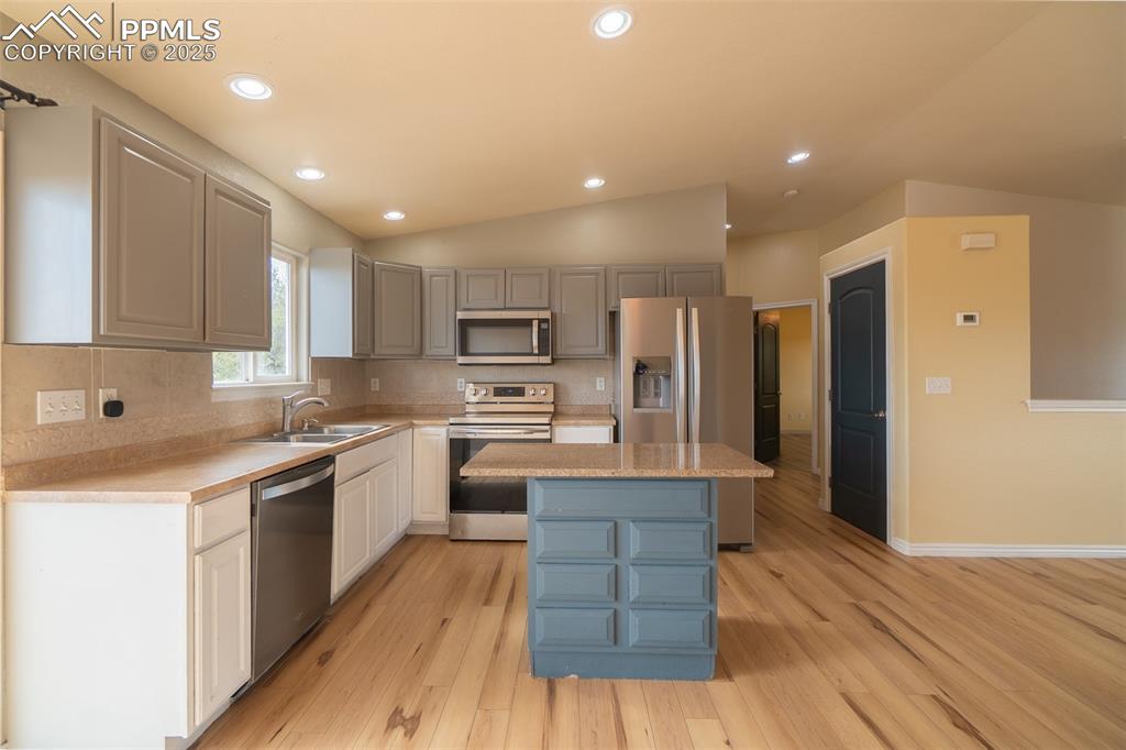 863 Circle Road Palmer Lake, CO 80133 - Photo 20 of 48 a kitchen with stainless steel appliances granite countertop wooden cabinets a stove top oven a sink and dishwasher