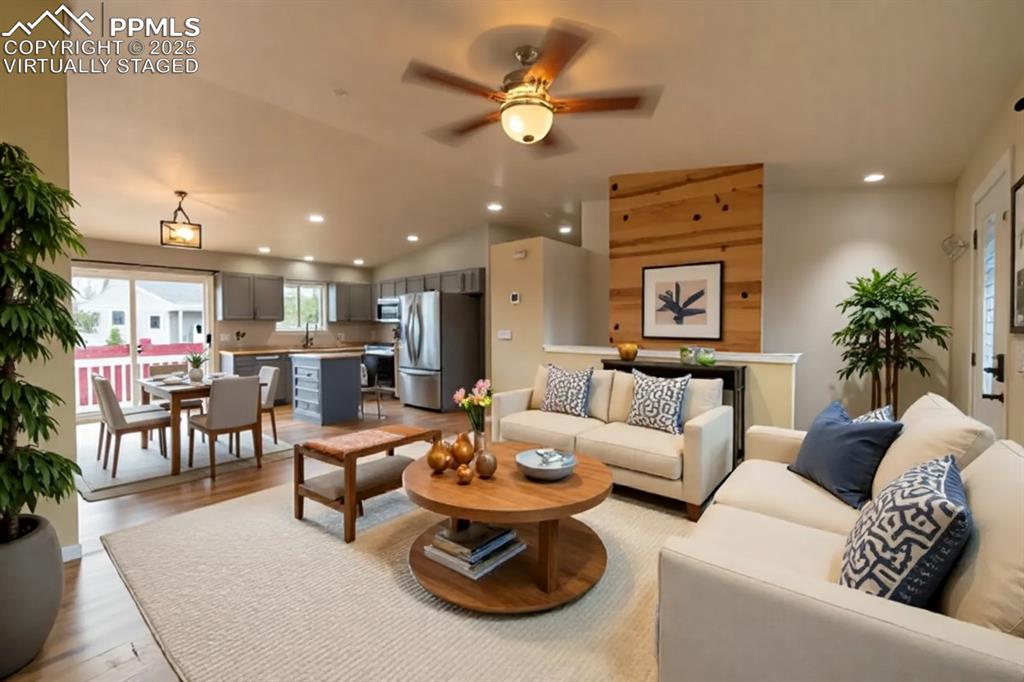 863 Circle Road Palmer Lake, CO 80133 - Photo 2 of 48 a living room with furniture kitchen view and a chandelier