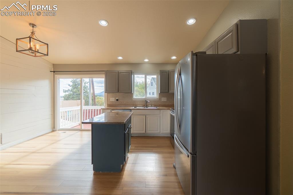 863 Circle Road Palmer Lake, CO 80133 - Photo 21 of 48 a kitchen with a refrigerator and a sink