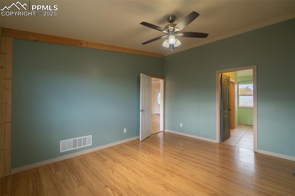 863 Circle Road Palmer Lake, CO 80133 - Photo 24 of 48 an empty room with wooden floor and windows
