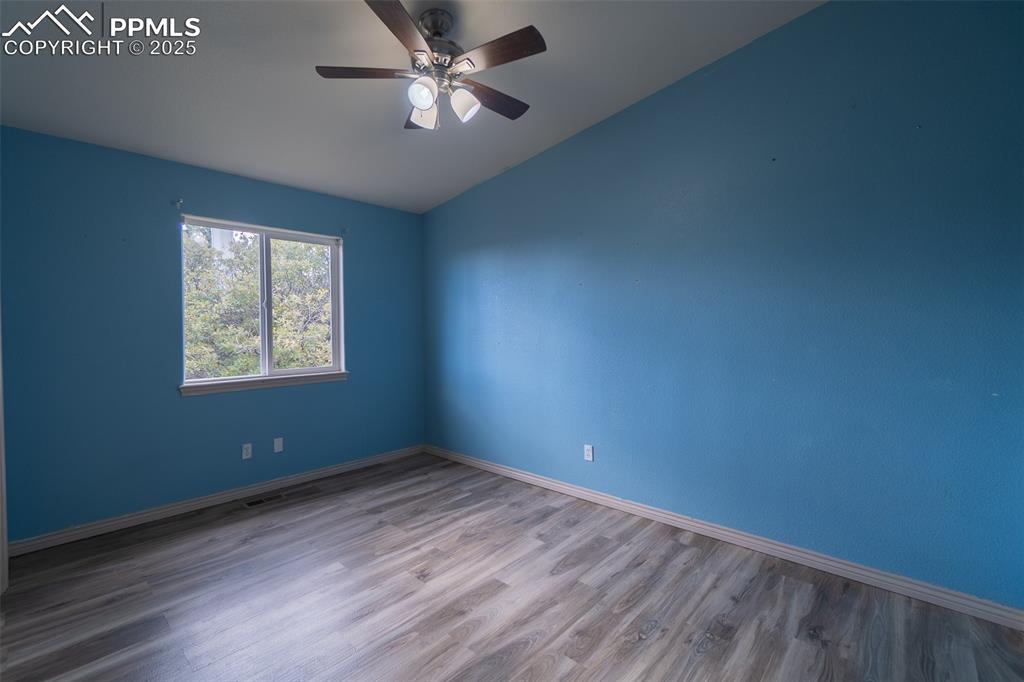 863 Circle Road Palmer Lake, CO 80133 - Photo 29 of 48 a view of empty room with wooden floor and fan