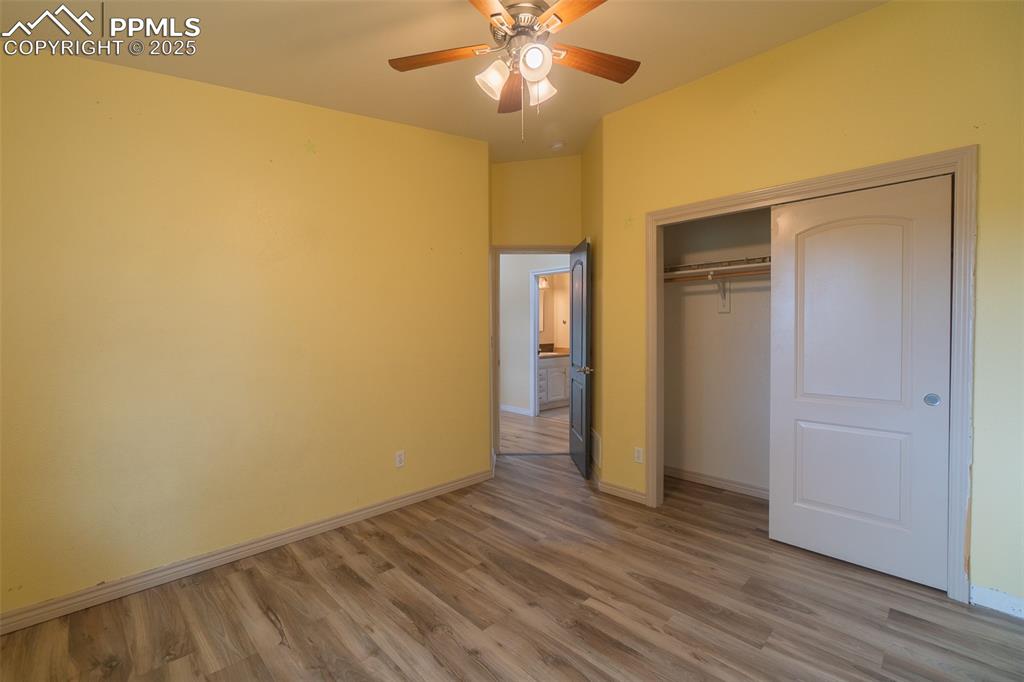 863 Circle Road Palmer Lake, CO 80133 - Photo 30 of 48 a view of an empty room with wooden floor
