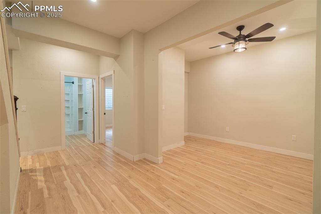 863 Circle Road Palmer Lake, CO 80133 - Photo 35 of 48 a view of a room with wooden floor and a ceiling fan