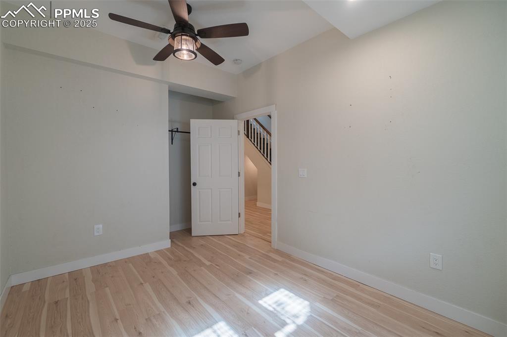 863 Circle Road Palmer Lake, CO 80133 - Photo 39 of 48 a view of an empty room with window and wooden floor