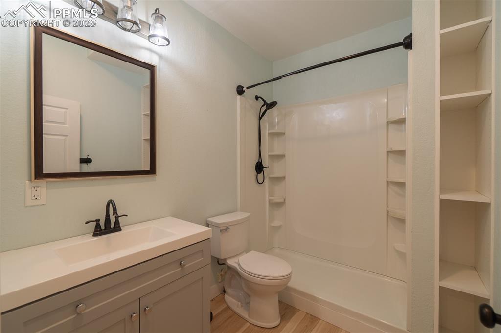 863 Circle Road Palmer Lake, CO 80133 - Photo 41 of 48 a bathroom with a toilet a sink and shower