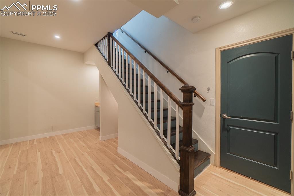 863 Circle Road Palmer Lake, CO 80133 - Photo 42 of 48 a view of hallway with wooden floor and stairs
