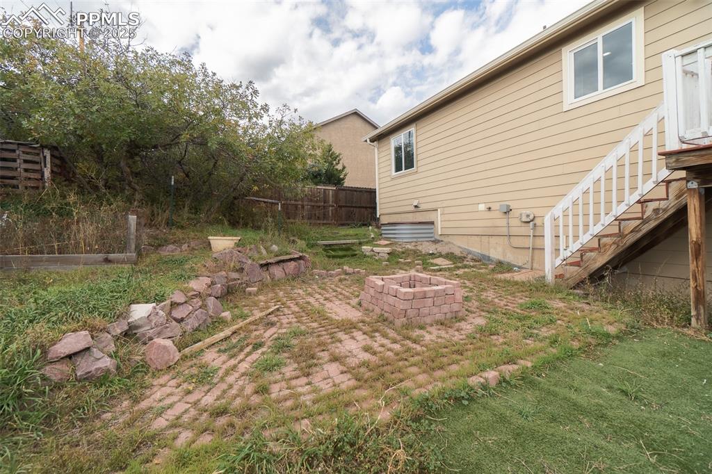 863 Circle Road Palmer Lake, CO 80133 - Photo 46 of 48 a view of a backyard with large trees and wooden fence