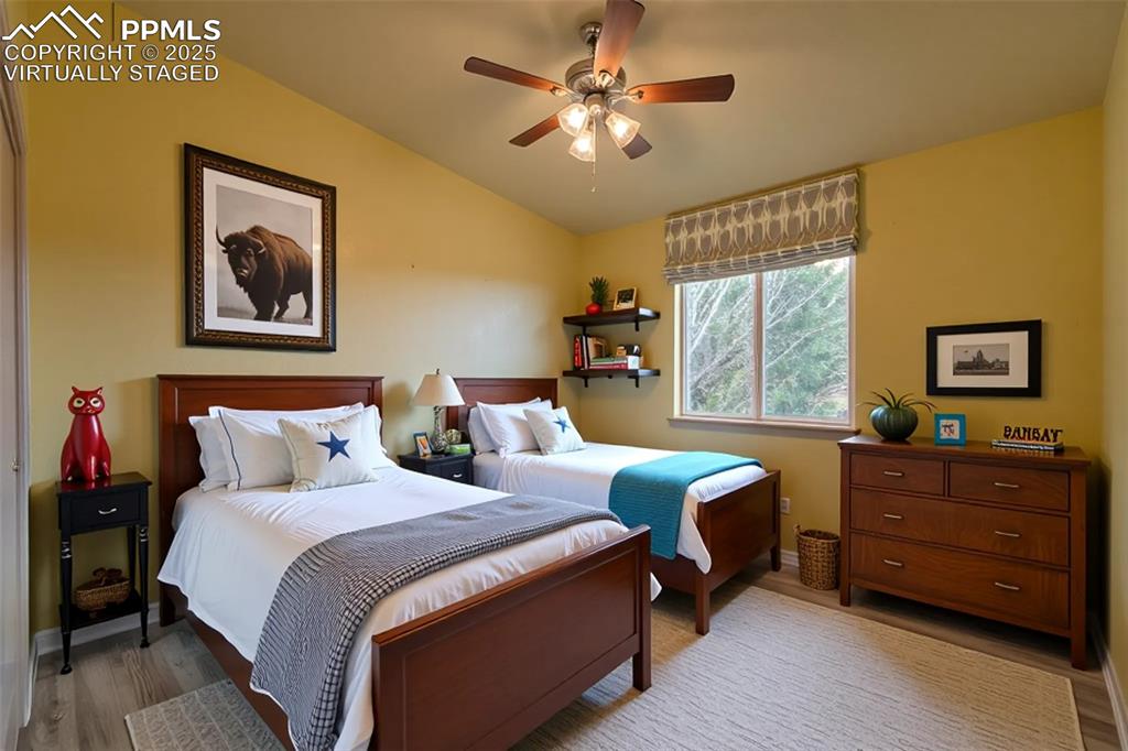 863 Circle Road Palmer Lake, CO 80133 - Photo 8 of 48 a bedroom with a bed and a table