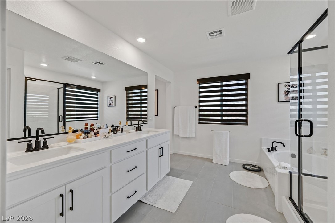 2933 Little Current Road North Las Vegas, NV 89086 - Photo 22 of 35 Dual vanity with pristine countertops and a sleek walk-in shower elevate this contemporary bathroom.