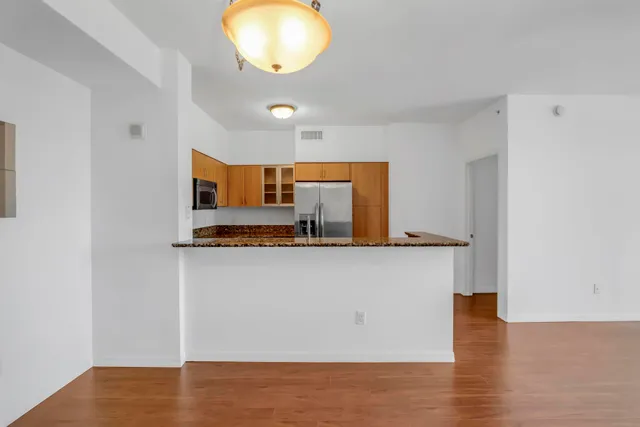 a view of kitchen cabinets and wooden floor