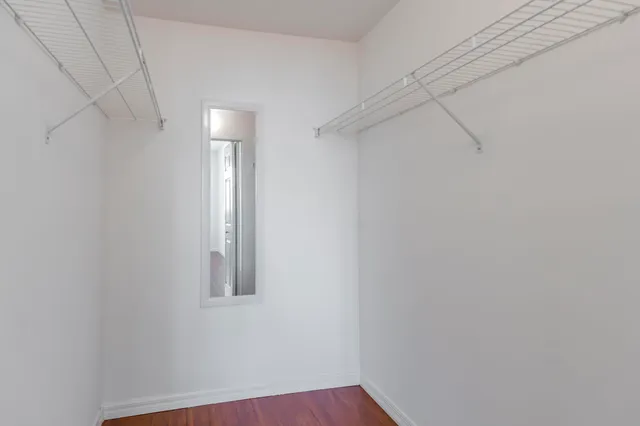 a bathroom with a granite countertop sink and a bathtub
