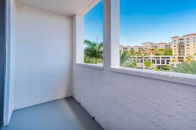 a view of a palm tree next to a building