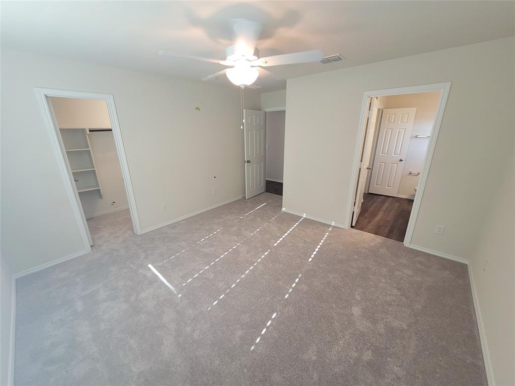 16029 Pemberly Lane Haslet, TX 76052 - Photo 9 of 19 a view of a big room with closet and chandelier fan
