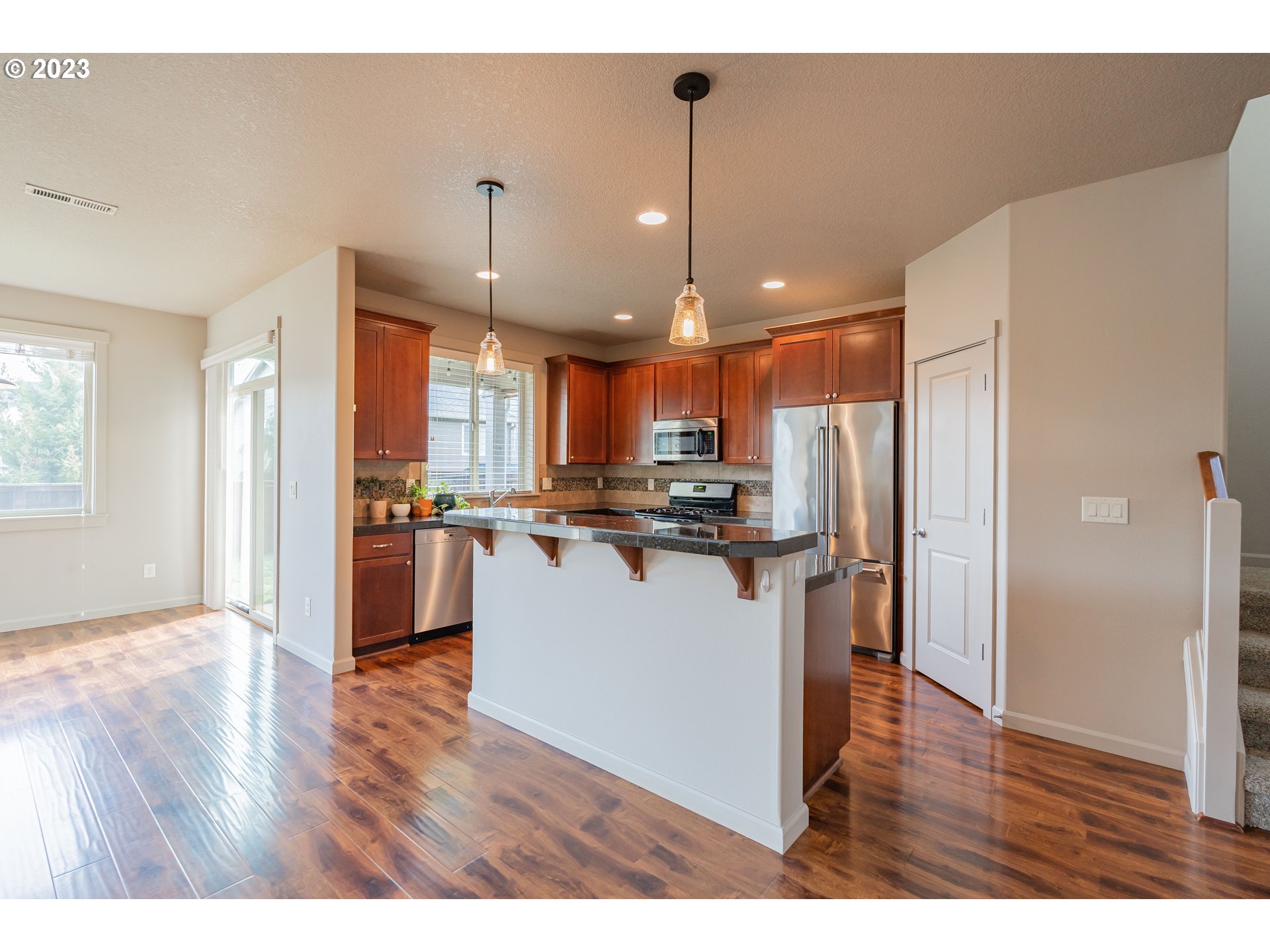 522 North 40th Avenue Ridgefield, WA 98642 - Photo 4 of 32 a view of kitchen with refrigerator and wooden floor