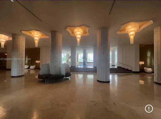 a view of a lobby with furniture and a chandelier