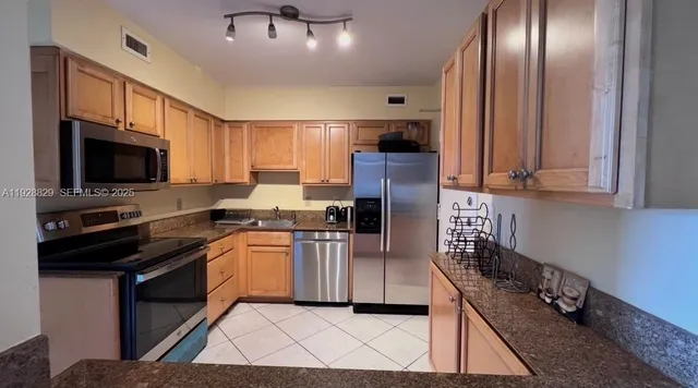 a kitchen with a sink stainless steel appliances and cabinets