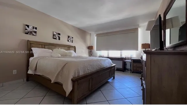 a bed room with a bed and a television