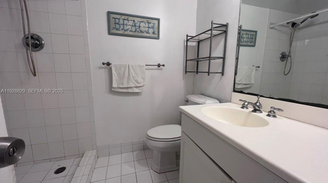 5161 Collins Avenue, Unit 1701 Miami Beach, FL 33140 - Photo 10 of 17 a bathroom with a sink a toilet and shower