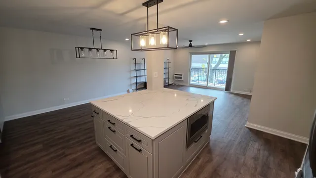 a kitchen with a stove and a wooden floor