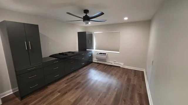 a living room with hard wood floors and a ceiling fan