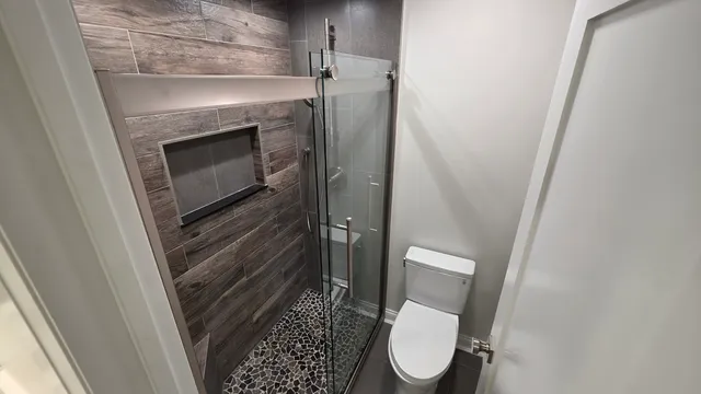 a bathroom with a toilet and a shower