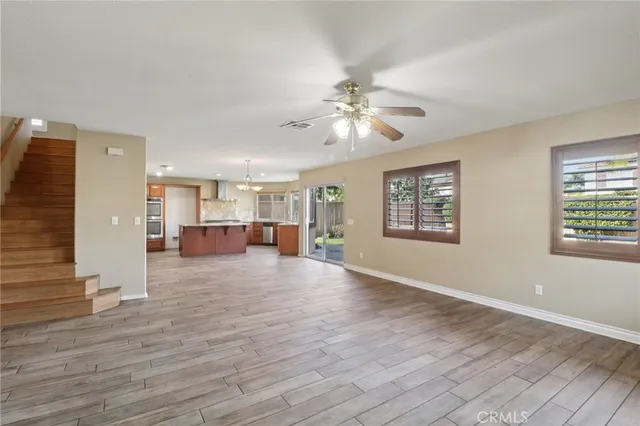 a view of a livingroom with hardwood floor and a ceiling fan