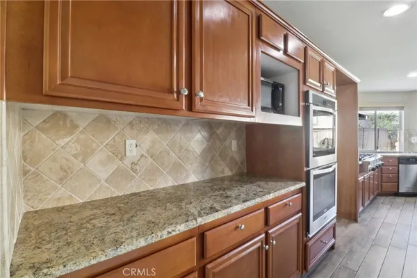 a view of open kitchen with granite countertop cabinets