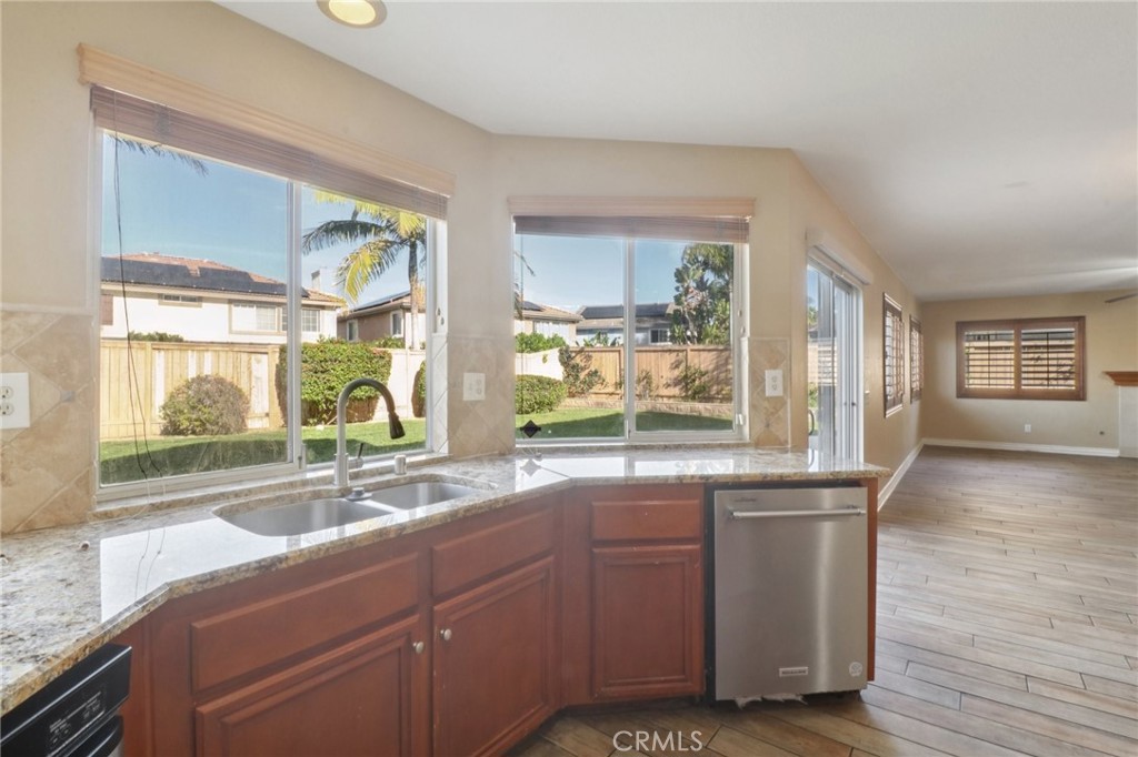 4310 Forest Ranch Way Oceanside, CA 92057 - Photo 15 of 50 a kitchen with granite countertop a stove and a sink