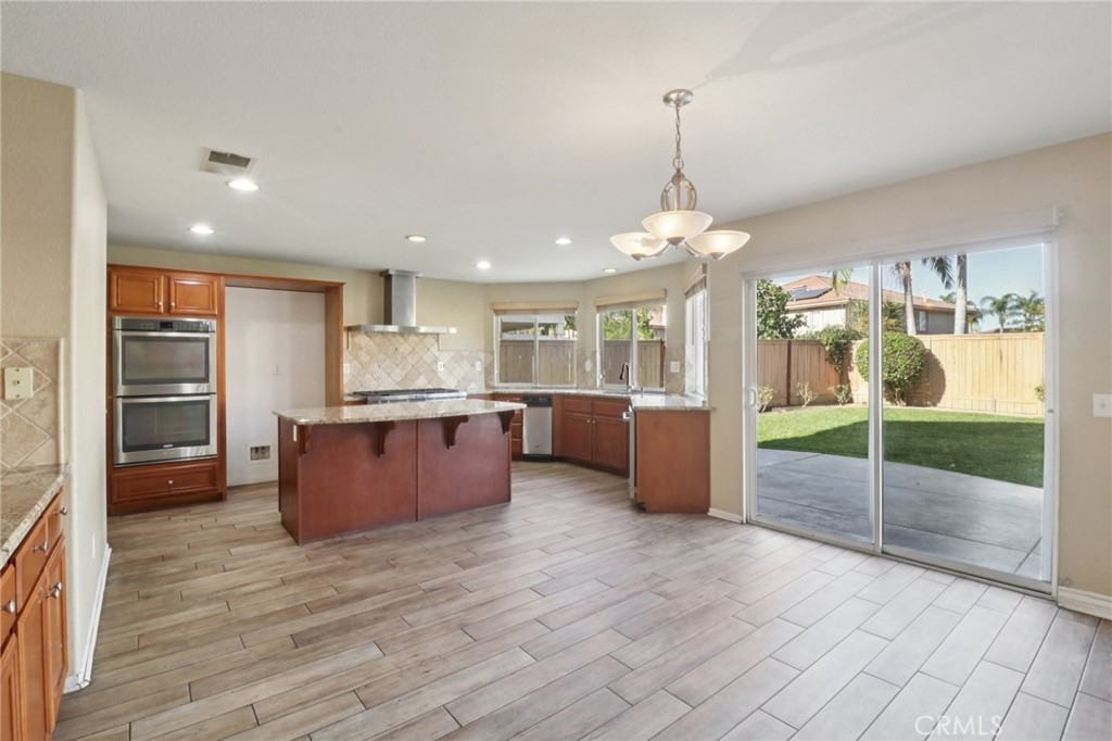 4310 Forest Ranch Way Oceanside, CA 92057 - Photo 17 of 50 a kitchen with stainless steel appliances granite countertop a refrigerator a sink a oven and a large window