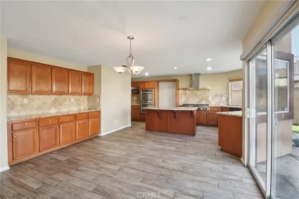 a large kitchen with kitchen island a sink stainless steel appliances and cabinets