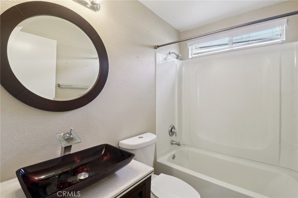 4310 Forest Ranch Way Oceanside, CA 92057 - Photo 18 of 50 a bathroom with a toilet a sink and a mirror