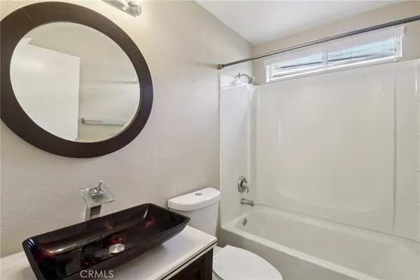 a bathroom with a toilet a sink and a mirror