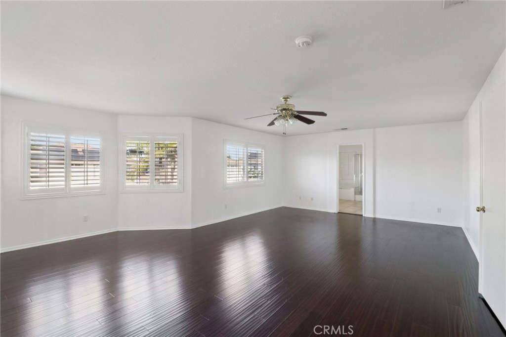 4310 Forest Ranch Way Oceanside, CA 92057 - Photo 20 of 50 a view of an empty room with wooden floor and a window
