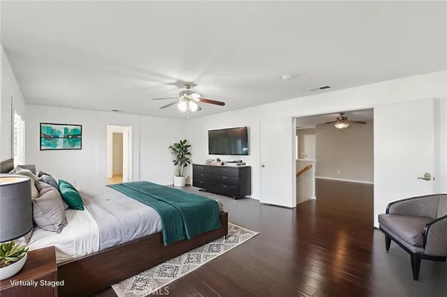 a bedroom with a bed and a television