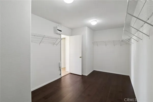 a view of a room with wooden floor and white walls