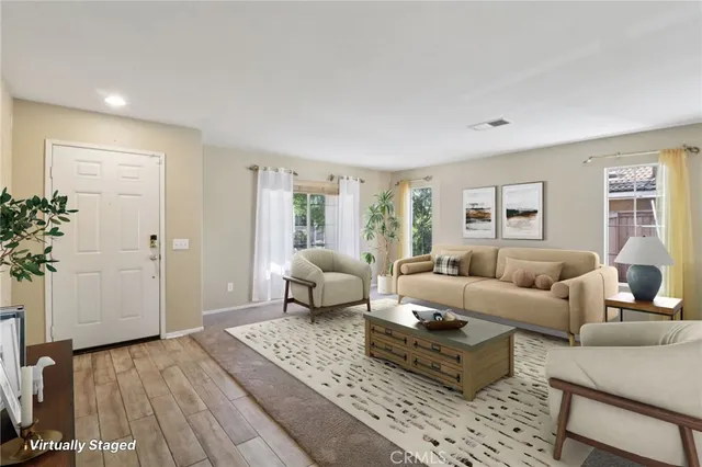 a living room with furniture and wooden floor